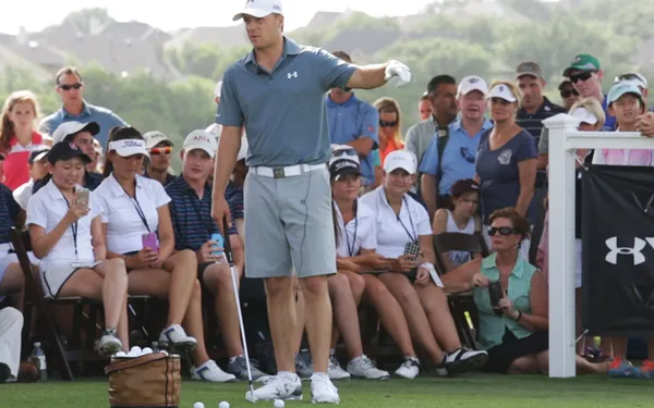 Jordan Spieth stands on a golf course.