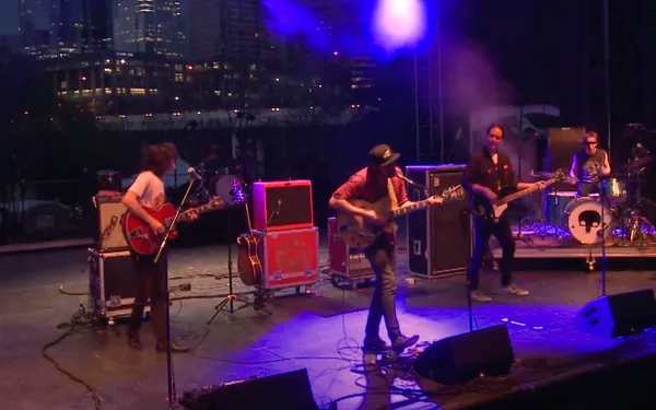A band performs on an outdoor stage.